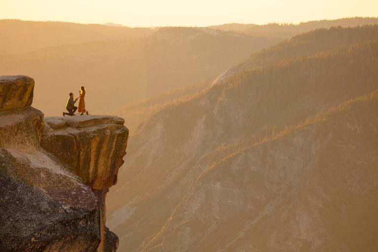 a group of people standing on a rock formation in the desert