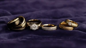 a close-up view of various men's wedding bands displayed elegantly on a velvet surface.